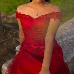 Red ballgown with lace details and a corset back